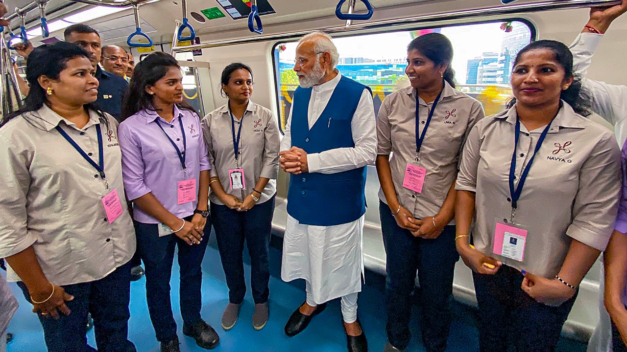 PM Modi is seen interacting with staff members while travelling in the metro. Credit: PMO