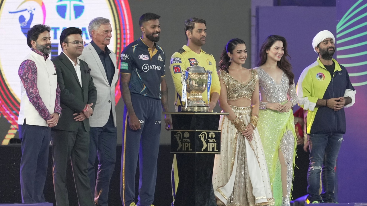 Chairman of IPL Arun Singh Dhumal, BCCI Secretary Jay Shah, BCCI President Roger Binny, Gujarat Titans captain Hardik Pandya, Chennai Super Kings captain Mahendra Singh Dhoni, actors Rashmika Mandanna & Tamannaah Bhatia and singer Arijit Singh pose for a photo during the IPL 2023 opening ceremony. Credit: PTI Photo
