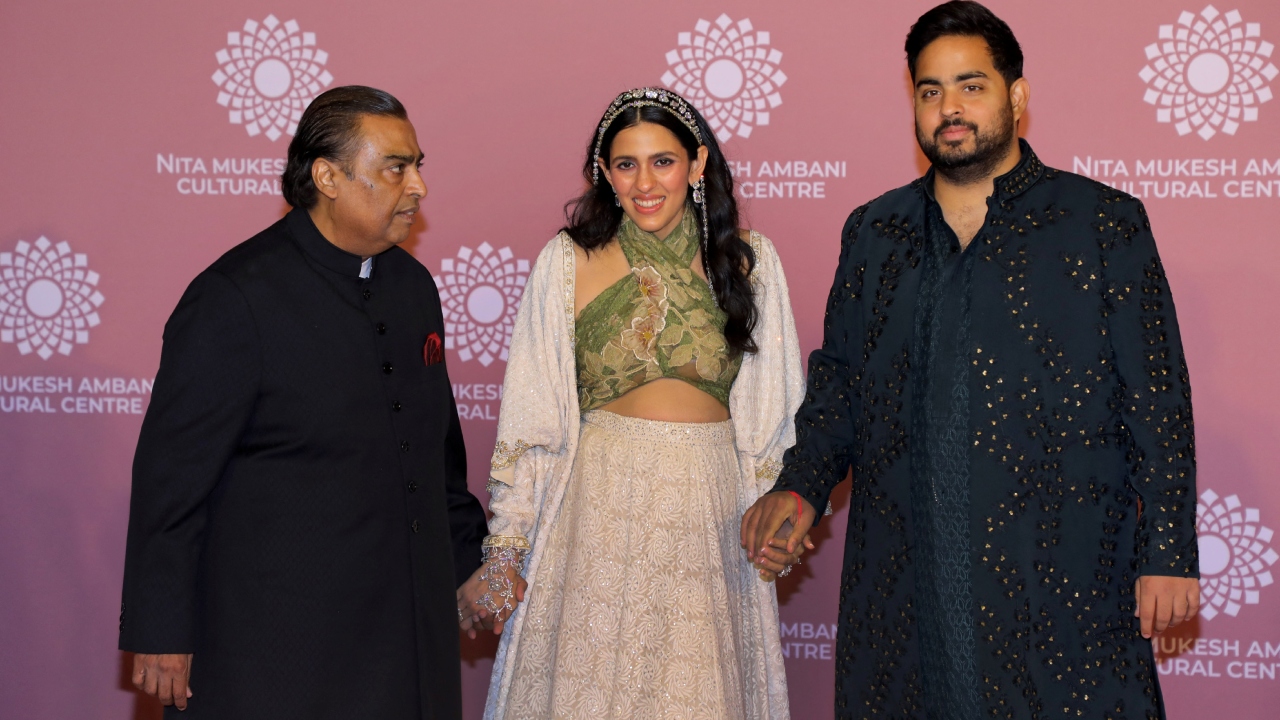 Pregnant Shloka Mehta is flanked by Aakash Ambani and Mukesh Ambani on Day 2 of the NMACC gala. Credit: AFP Photo