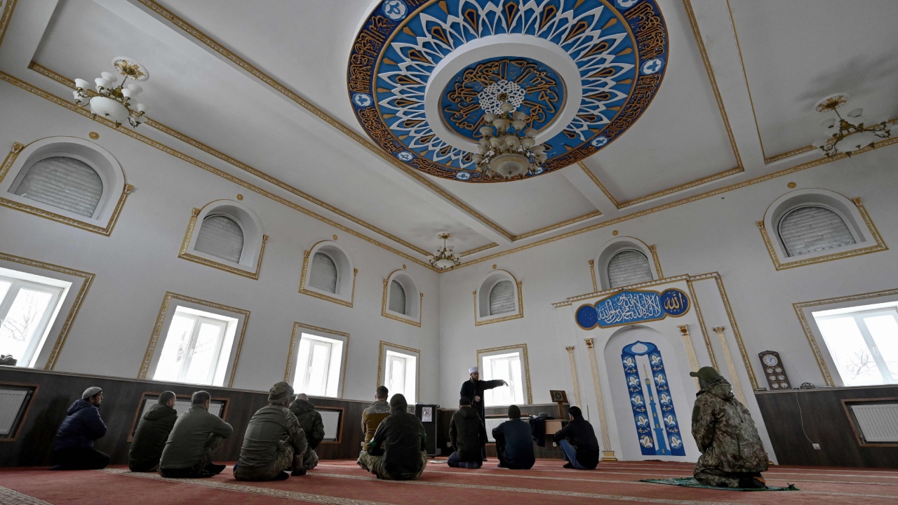 Worshippers listen to the Friday prayers sermon at a mosque near the eastern front line, amid the Russian invasion of Ukraine. Credit: AFP Photo