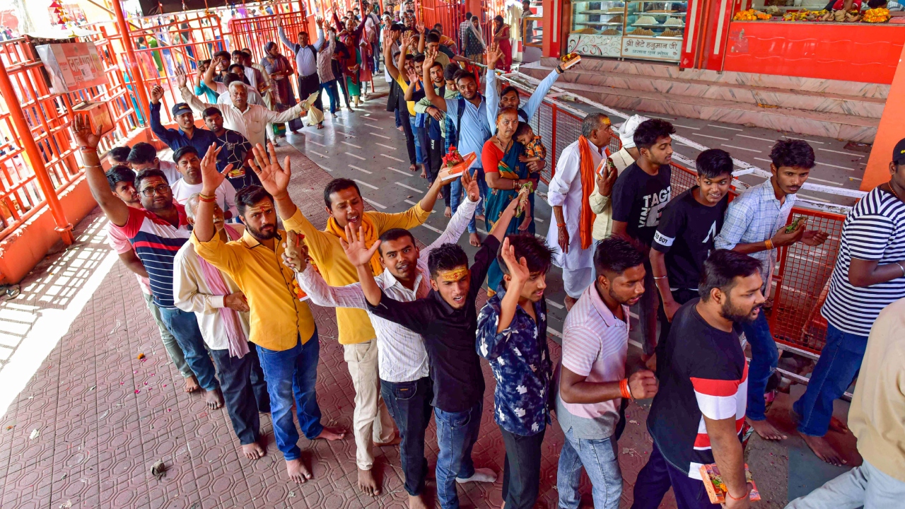 Devotees arrive to offer prayers at Bade Hanuman Ji temple on the occasion of 'Hanuman Jayanti', near Sangam in Prayagraj. Credit: PTI Photo