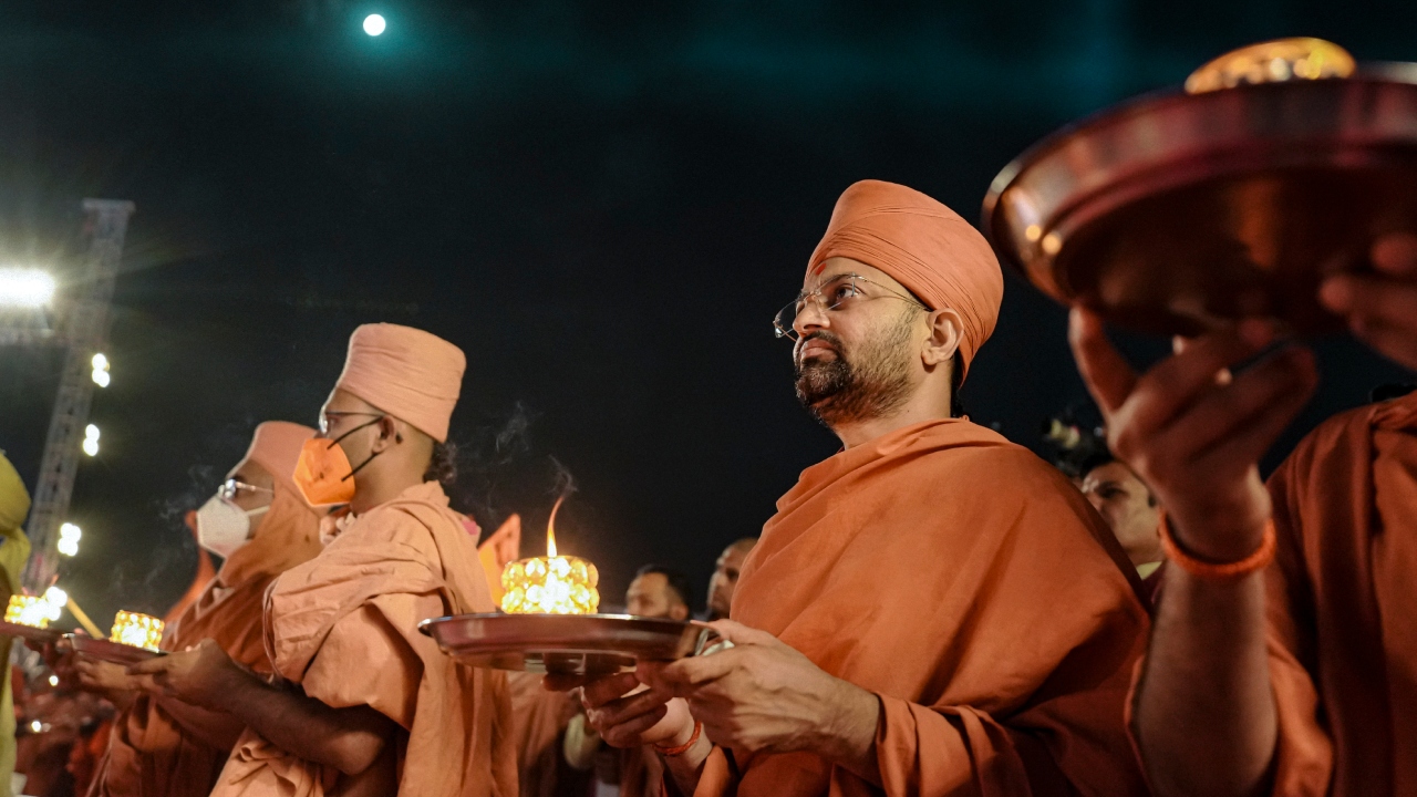Swaminarayan Saints offer prayers to a 54 feet tall statue of Lord Hanuman at Salangpur, in Botad, Gujarat. Credit: PTI Photo