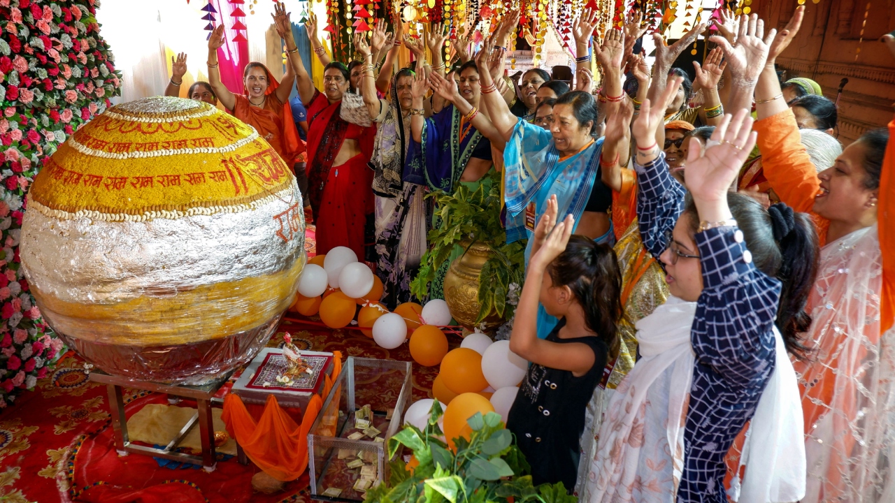 Devotees offer prayers near an 1100 kg laddoo, prepared to offer to Lord Hanuman, on the eve of Hanuman Jayanti, at the Pachmattha temple, in Jabalpur. Credit: PTI Photo