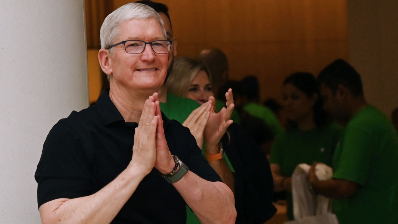 With folded hands Apple chief executive Tim Cook welcomed the customers at the company's first store opened in the national capital. Credit: AFP Photo
