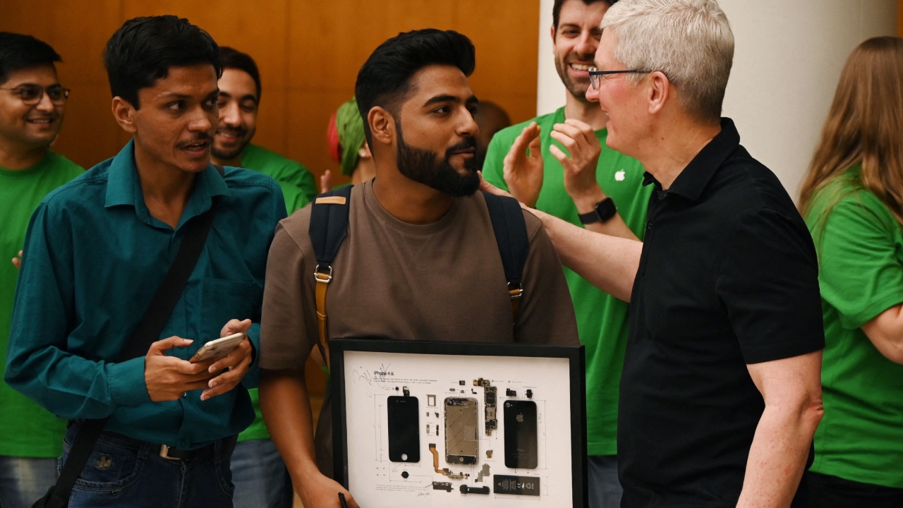 Chief Executive Officer of Apple Tim Cook (R) talks with Apple enthusiasts during the opening of an Apple retail store at a mall in New Delhi. Credit: AFP Photo