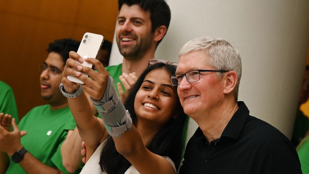 Chief Executive Officer of Apple Tim Cook poses for a selfie with a woman during the opening of an Apple retail store at Select City Skywalk mall in New Delhi. Credit: AFP Photo