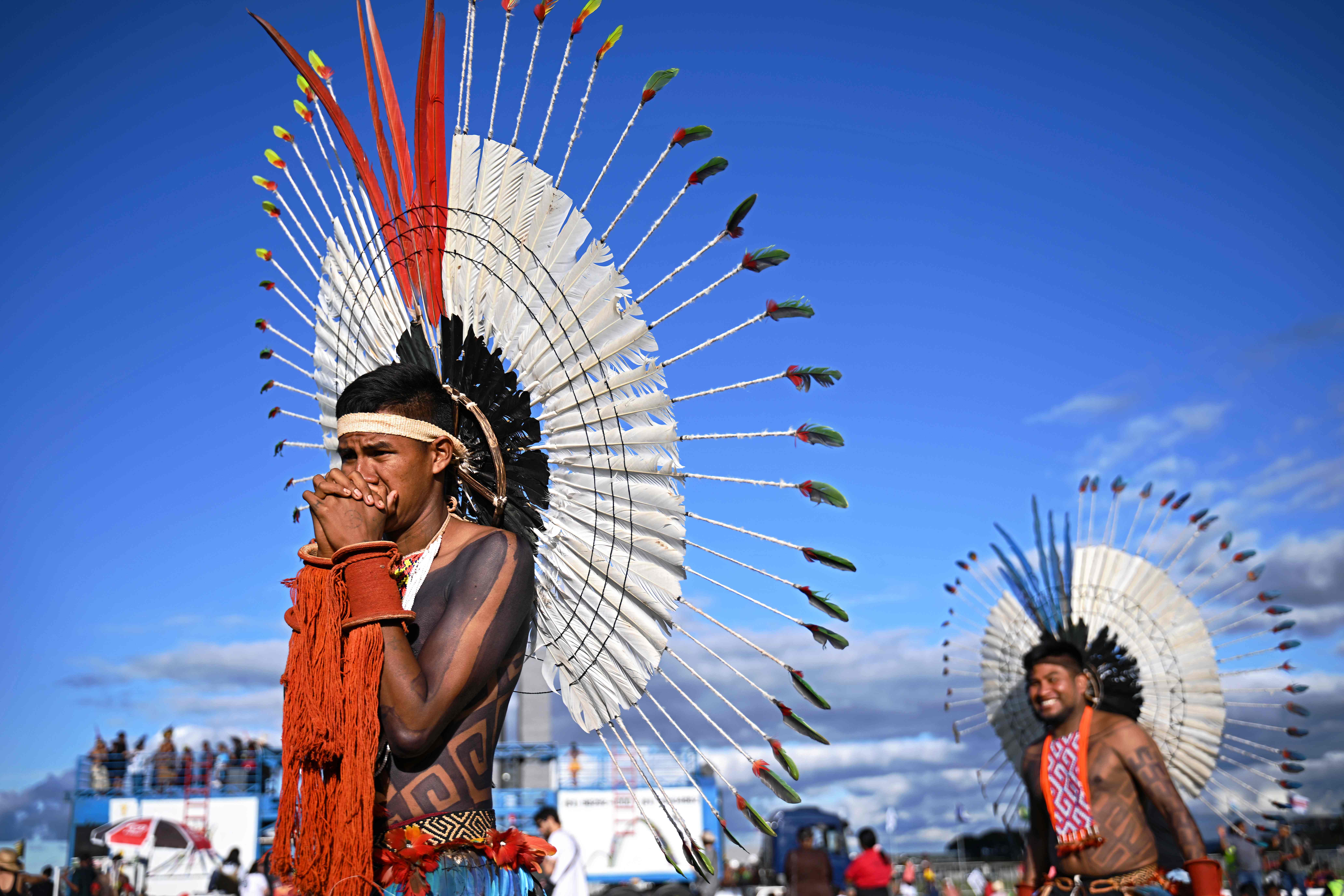 Indigenous people taking part in the Terra Livre Indigenous camp, focused on bringing awareness for indigenous rights and land issues and promoting their culture, protest outside the Congress building in Brasilia. Credit: AFP Photo