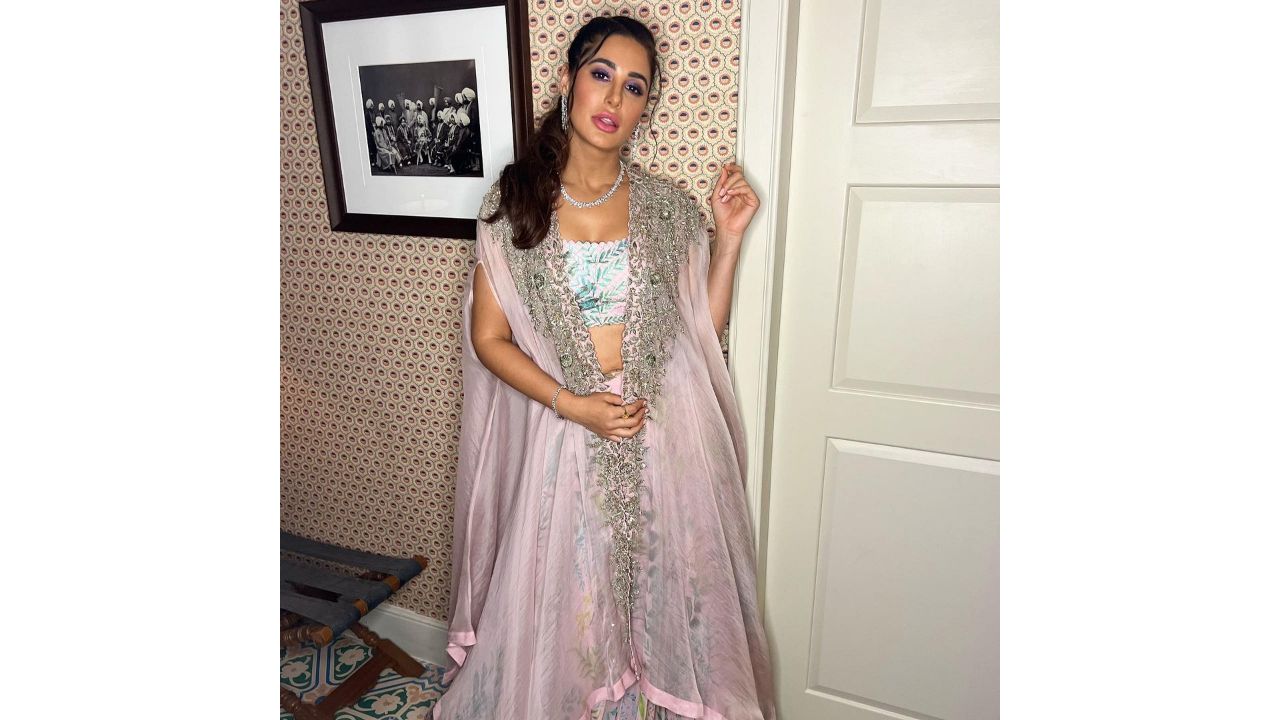 Nargis dazzles in a Mrunalini Rao zardozi embroidered organza cape paired with leaf printed chiffon skirt and embellished blouse. Credit: Instagram/@nargisfakhri