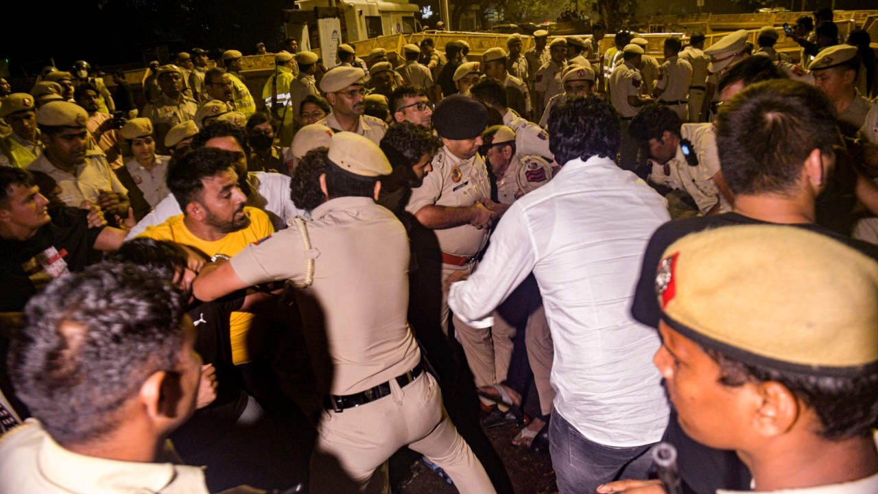 Police personnel and wrestlers engage in a scuffle at Jantar Mantar, in New Delhi. Credit: PTI Photo