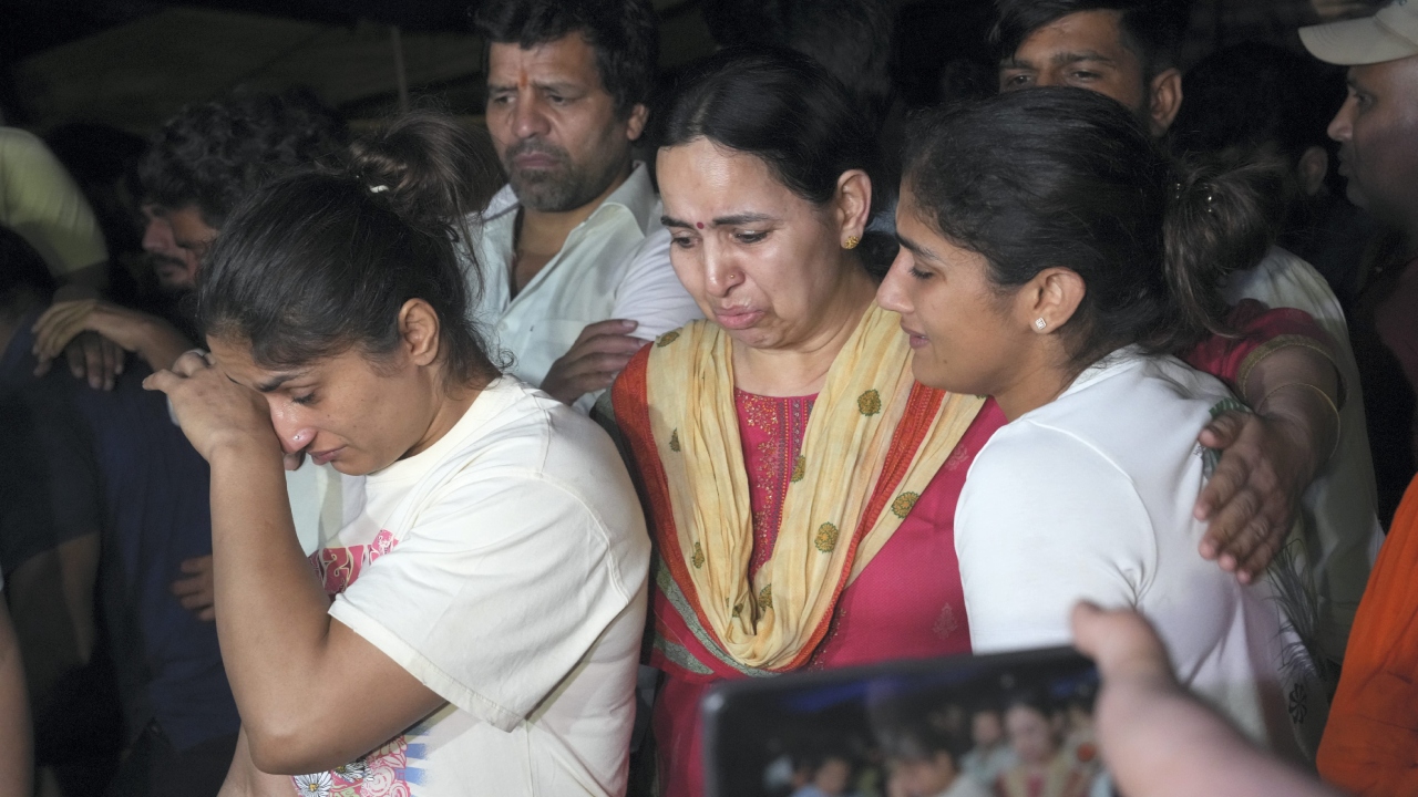 Wrestlers get emotional after the scuffle with the police at Jantar Mantar, in New Delhi. Credit: PTI Photo