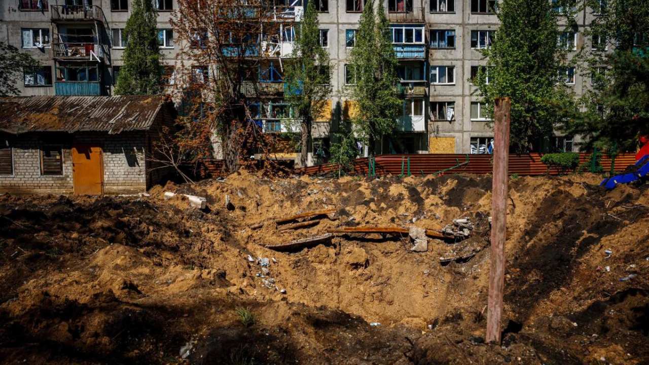A photograph shows a damaged residenial buildin and crater, after missile strikes in Chasiv Yar near the frontline city of Bakhmut, Donetsk region on May 3, 2023, amid the Russian invasion of Ukraine. Credit: AFP Photo