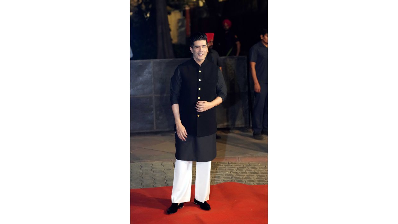 Fashion designer Manish Malhotra was seen dressed in a black and white kurta pyjama with jacket for the engagement party. Credit: PTI Photo