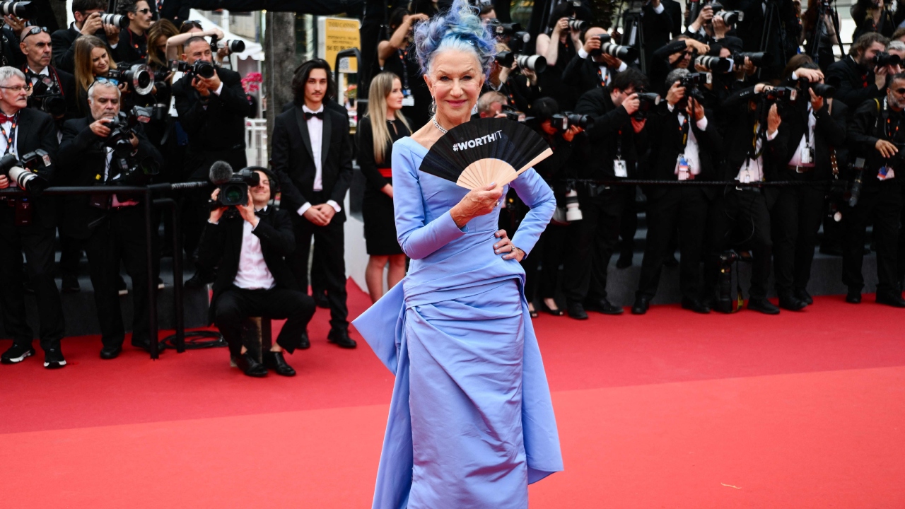 Actor Helen Mirren was seen walking the red carpet in a fitted pale purple gown with silver platform heels. Credit: AFP Photo