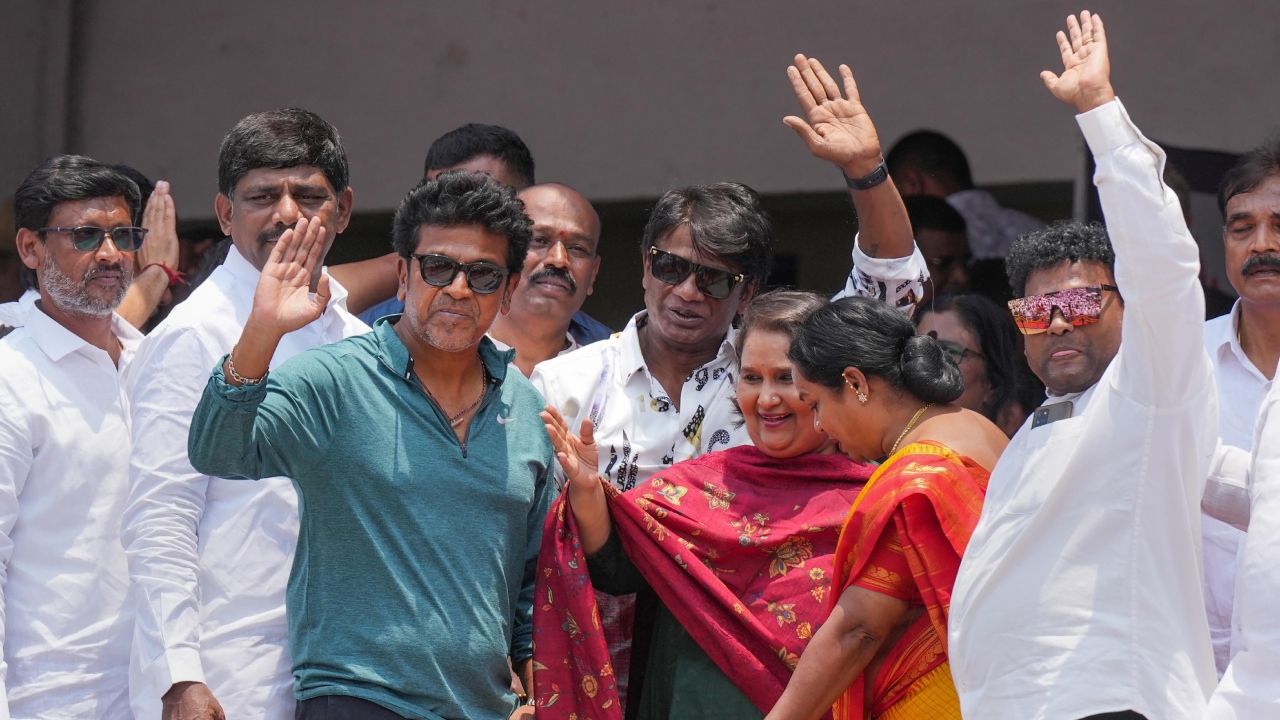 Kannada actor Shivaraj Kumar, Duniya Vijay and Umashree with MP D K Suresh greet the reporters and crowd. Credit: PTI Photo