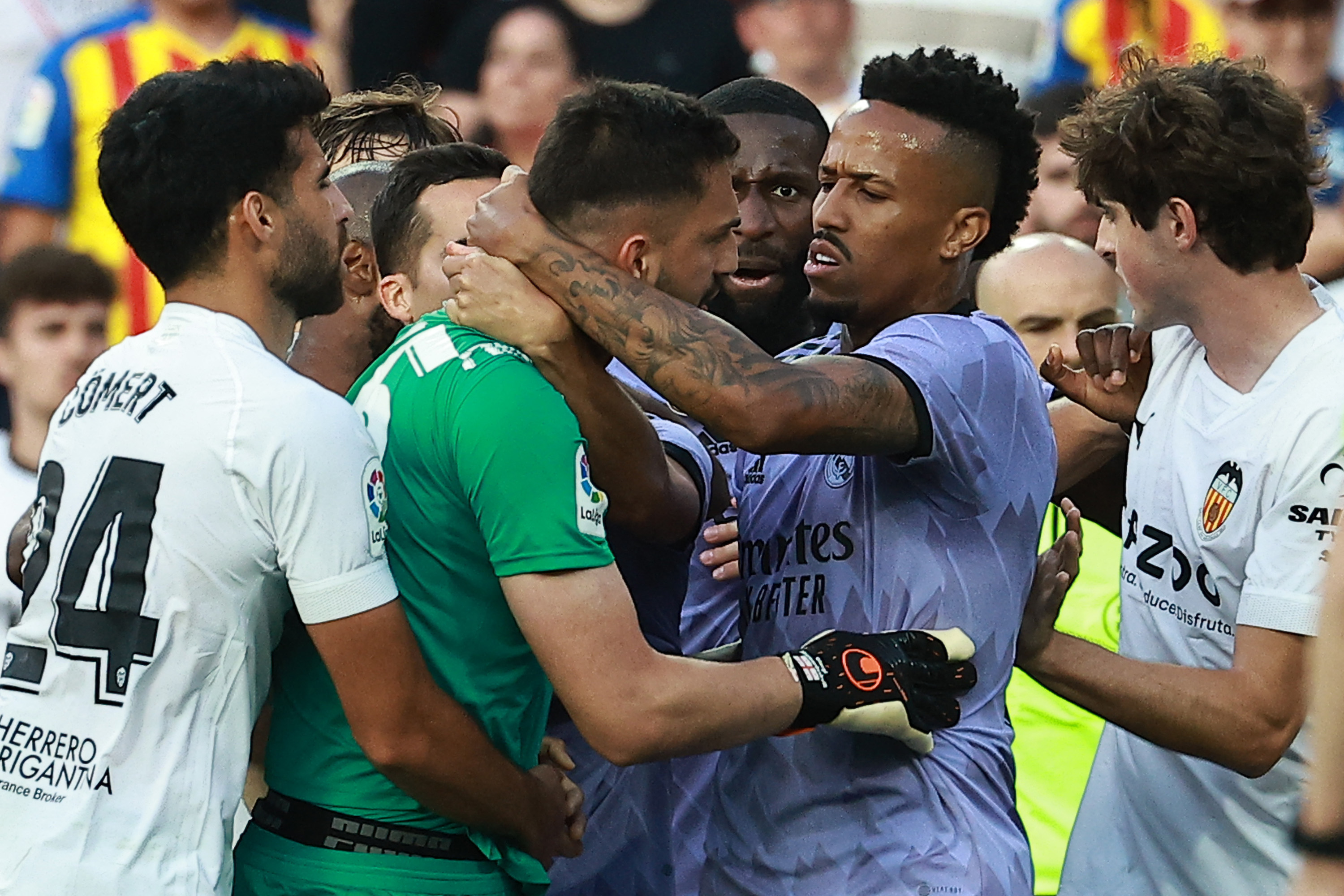 Valencia's Georgian goalkeeper Giorgi Mamardashvili (C) argues with Real Madrid's Brazilian defender Eder Militao (2R) and teammates during the Spanish league football match between Valencia CF and Real Madrid CF at the Mestalla stadium in Valencia. Credit: AFP Photo
