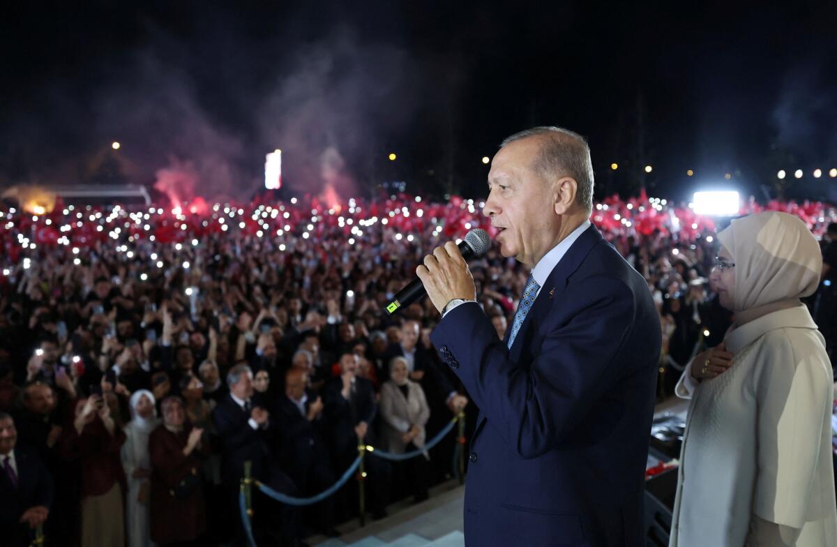 Turkish President Tayyip Erdogan, accompanied by his wife Emine Erdogan, addresses his supporters at the Presidential Palace in Ankara. Credit: Reuters Photo