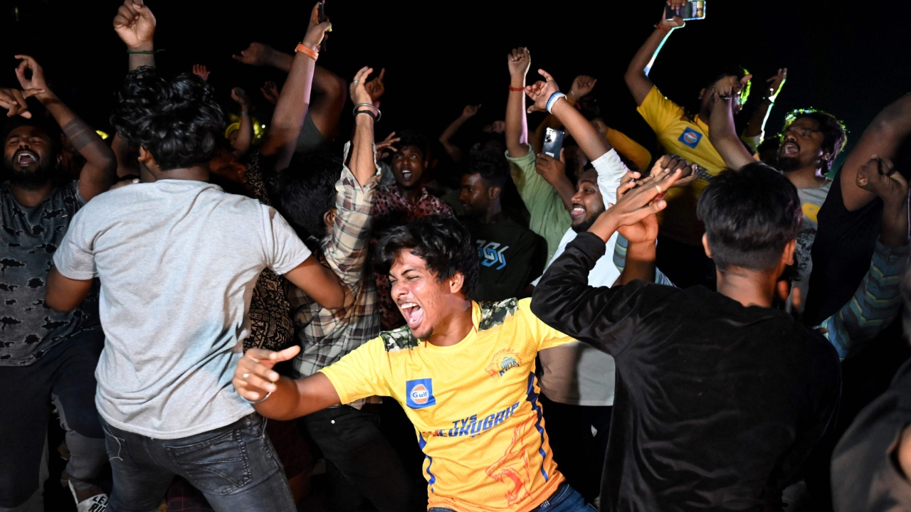 Chennai Super Kings' fans celebrate their team's win at the end of the Indian Premier League (IPL) Twenty20 final cricket match between Gujarat Titans and Chennai Super Kings, at a drive-in theatre live streaming the match in Chennai. Credit: AFP Photo