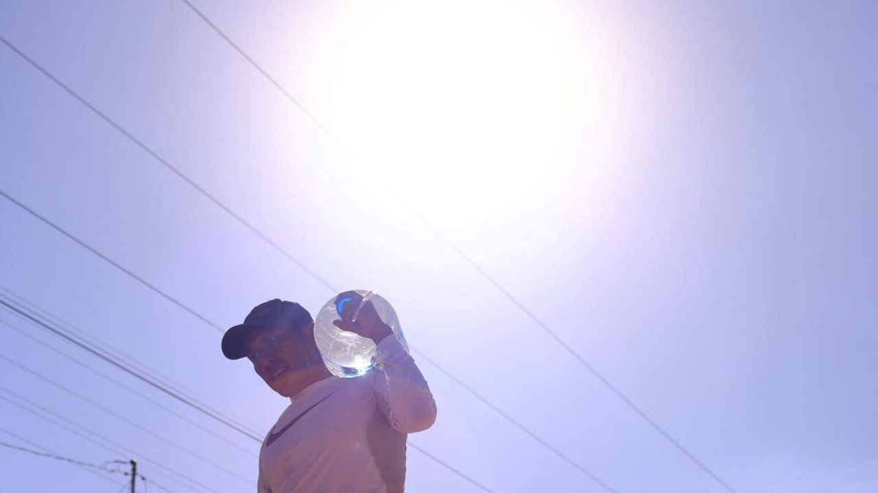 A man carries a container filled with water during high temperatures in the Anapra neighbourhood in Ciudad Juarez, Mexico, June 15, 2023. Credit: Reuters Photo