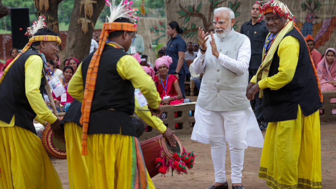 PM Modi received a warm welcome as he was set to interact with tribal leaders in the district. Credit: PTI Photo