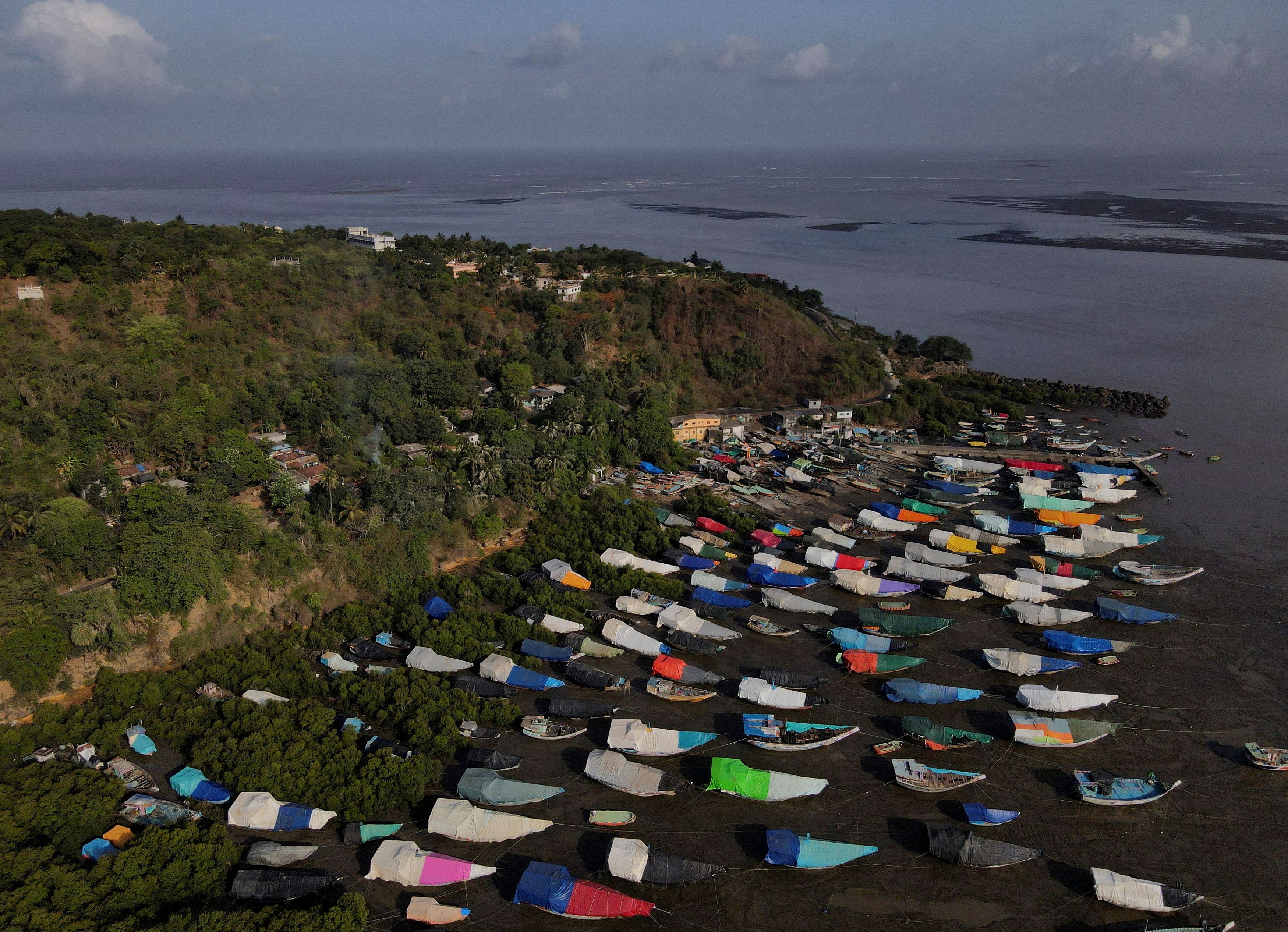 An aerial view of fishing boats covered with tarpaulin sheets parked on the shore, before the start of the monsoon season, on the outskirts of Mumbai. Credit: Reuters Photo