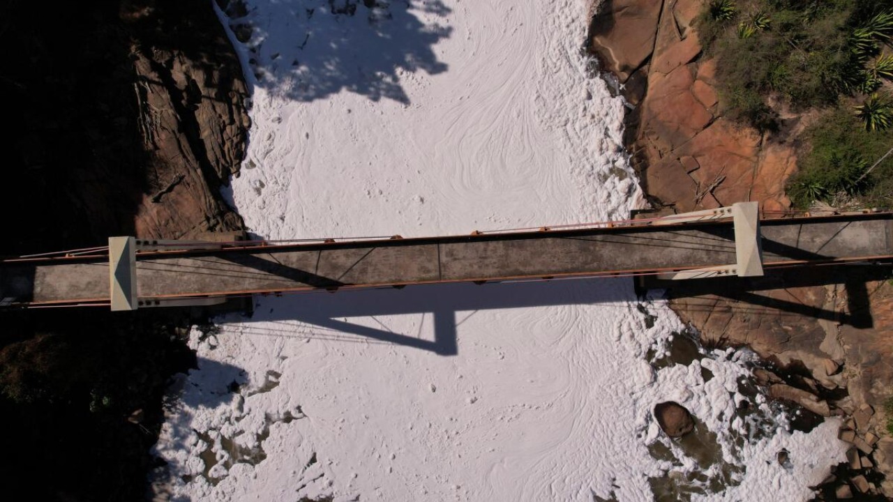 A bridge is seen over Tiete river, where toxic foam, product of the discharge of chemical products, covers the water in Salto, Sao Paulo state, Brazil July 7, 2023. Credit: Reuters Photo