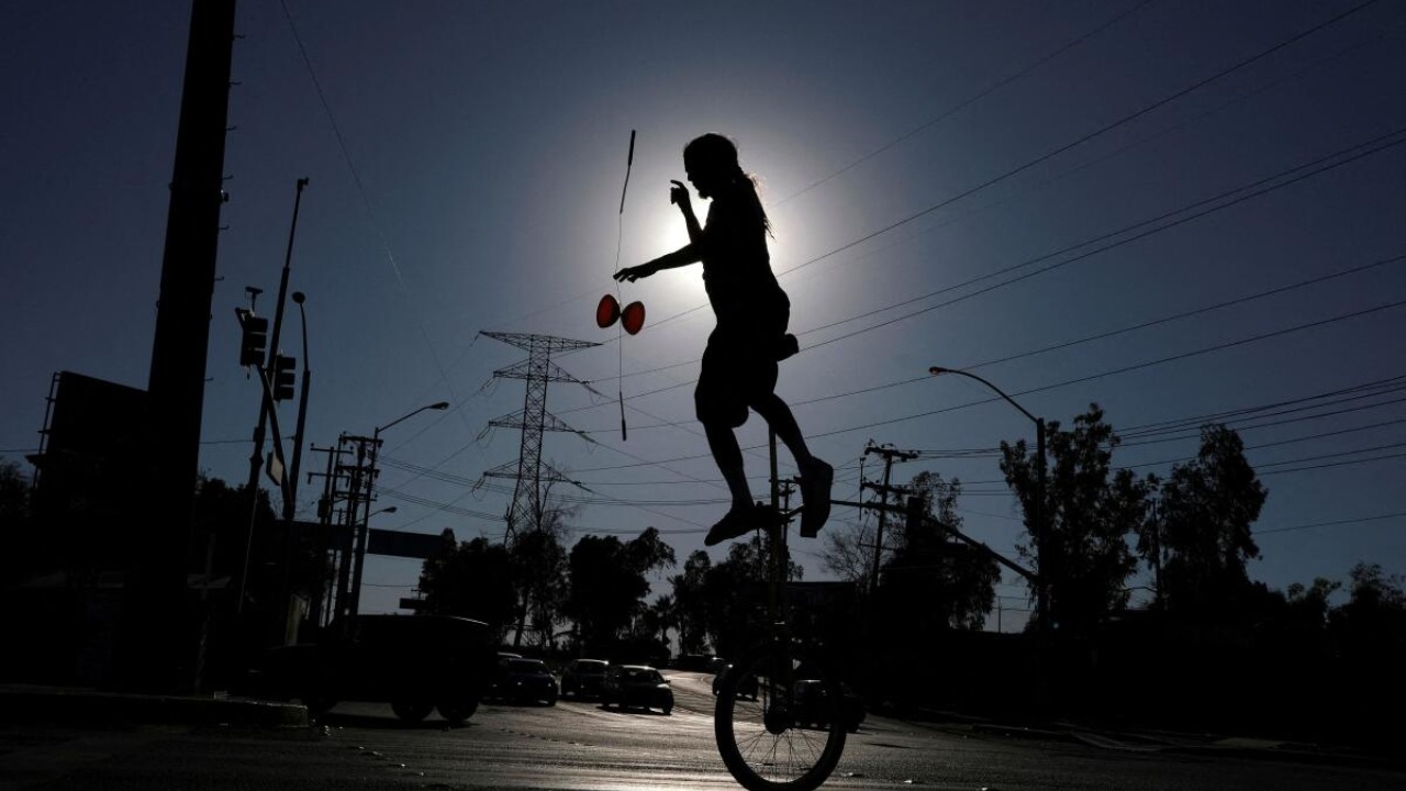 Street artist performs in an avenue under the intense heat as the temperature reaches 122 degrees Fahrenheit (50 Celsius), in Mexicali, Baja California state, Mexico July 2, 2023. Credit: Reuters Photo