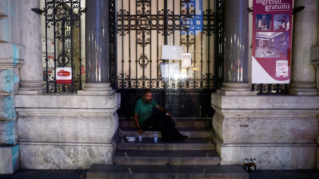 Steven from Croatia who is homeless and sleeps on the stairs of a museum looks on after he has been given a bottle of water, some pasta and cold tea by Red cross workers as they check on homeless, during a heatwave across Italy, in Rome, Italy July 21, 2023. Credit: Reuters Photo