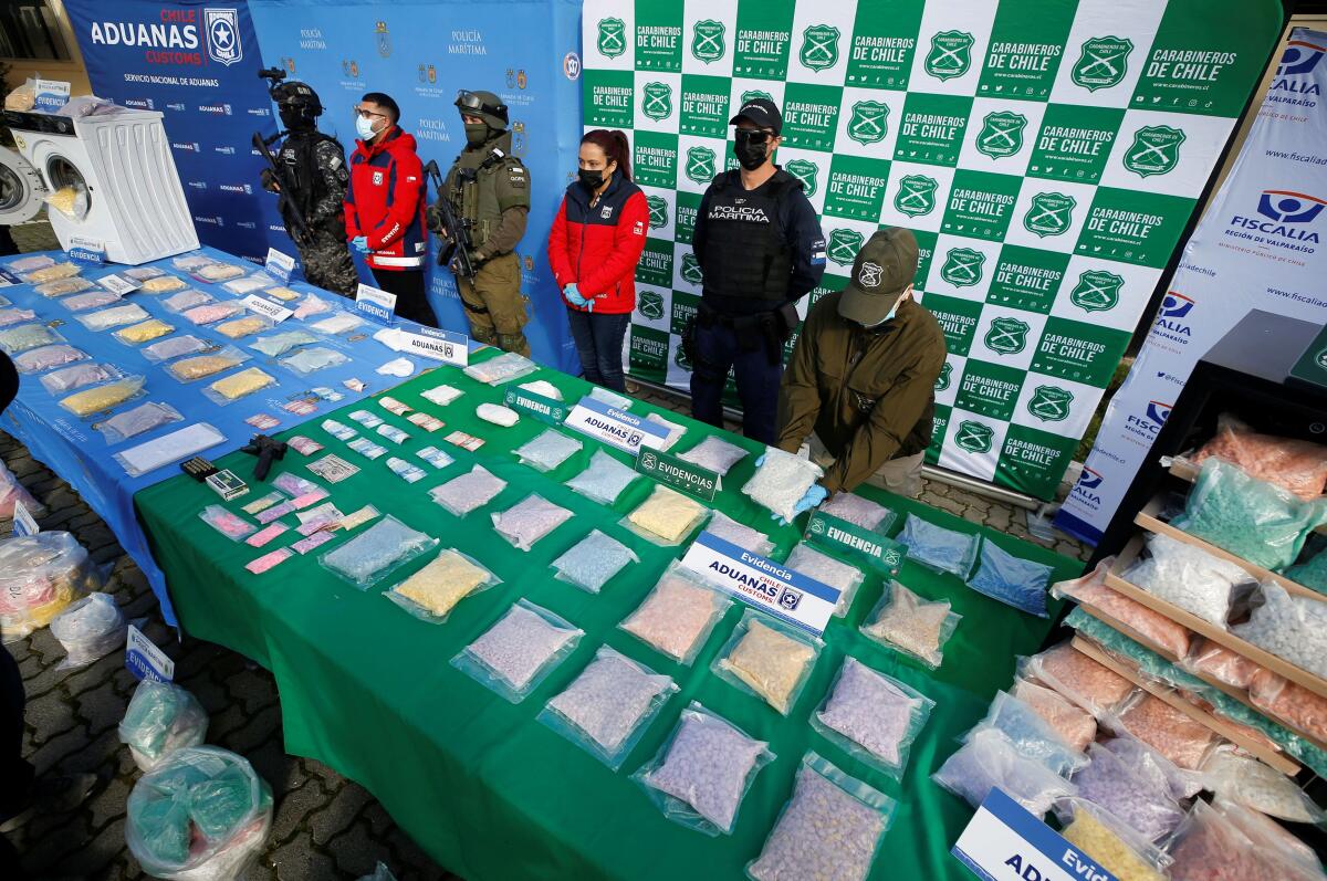 Members of the Chilean Navy, next to Customs and police officers of the Carabineros de Chile, display a seizure of the drug ecstasy, which was shipped from a Belgium port. Credit: Reuters Photo