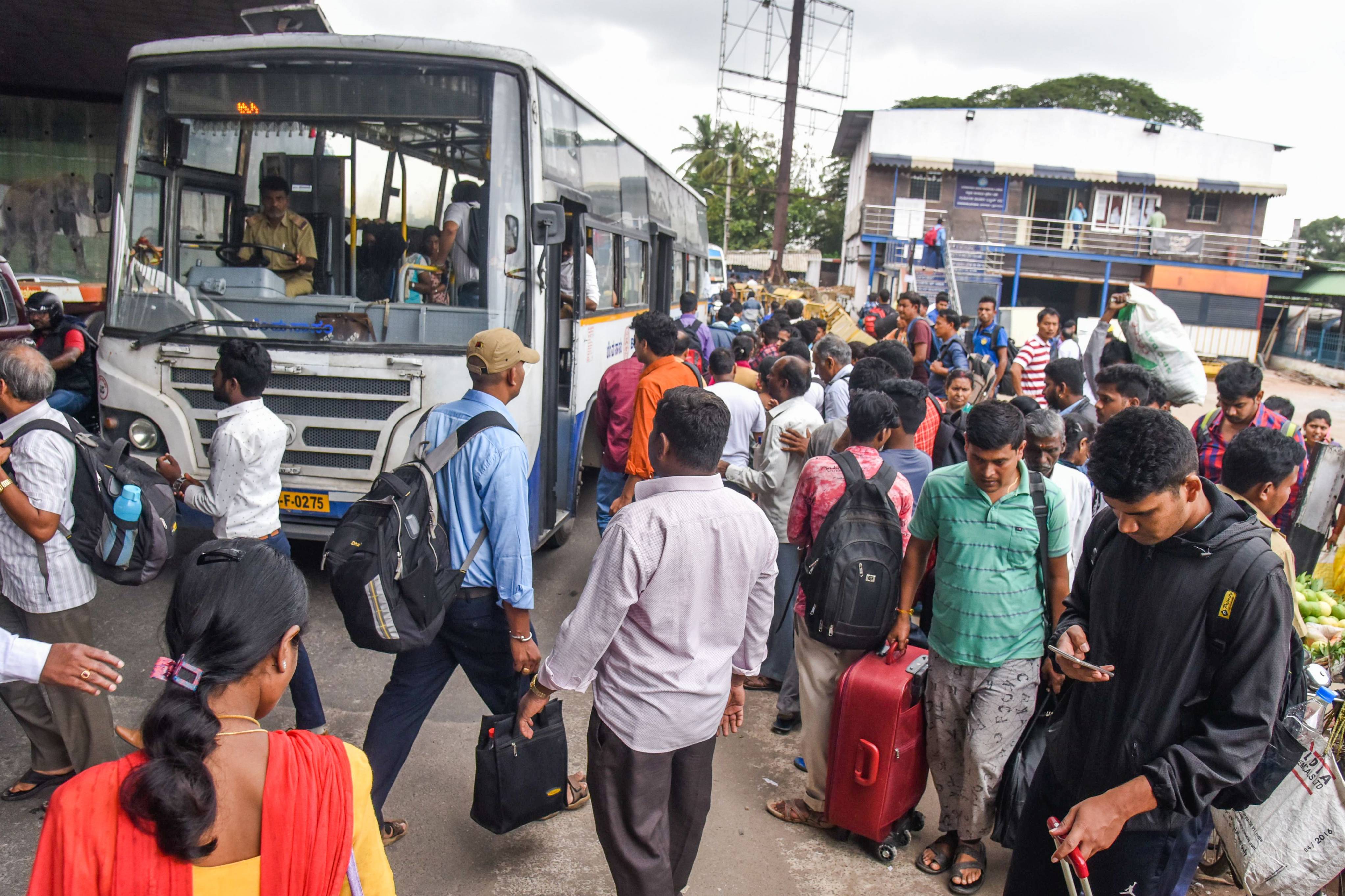 So many people wait for buses near K R Puram railway station where buses are the lifeline. (DH Photo/S K Dinesh)