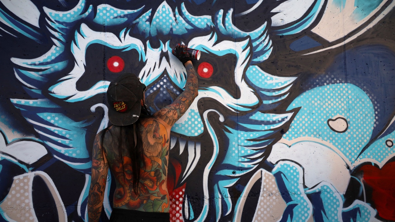 Julian Santamaria, a graffiti artist from Colombia, paints a mural as part of the Meeting of Styles graffiti festival in Kosovo's capital Pristina, Kosovo July 29, 2023. Credit: Reuters Photo