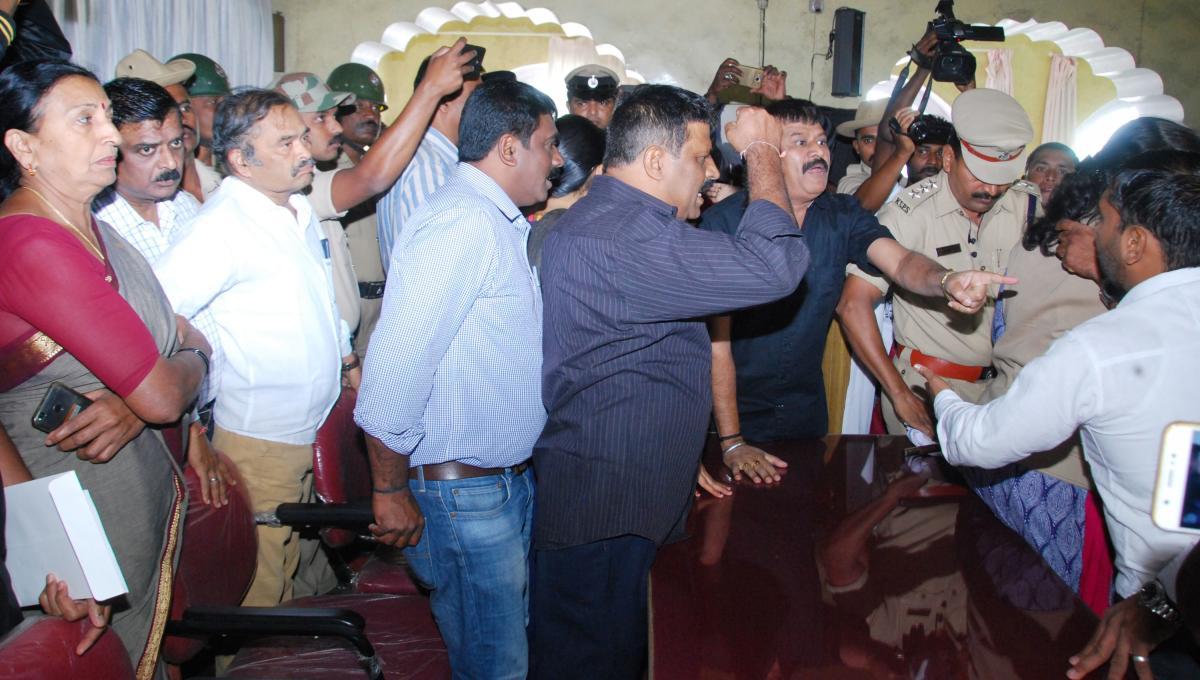 Elected representatives from the BJP and Congress engage in arguments before the Tipu jayanti event at the old fort hall premises in Madikeri. dh photo