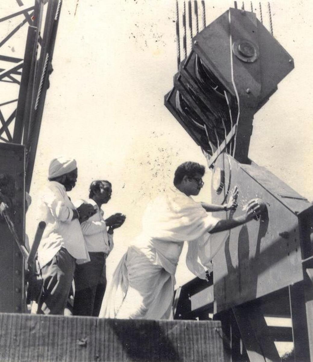 Witness: Maha Mastakabhisheka ceremony at Dharmastala; Brahmastamba ferried on a truck; installation of the Bahubali monolith atop Rathnagiri hill, priest conducting rituals while installing the monolith.