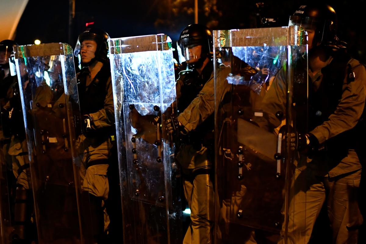 Riot police stand guard after a march against a controversial extradition bill in Hong Kong on July 21, 2019. (Photo by AFP)