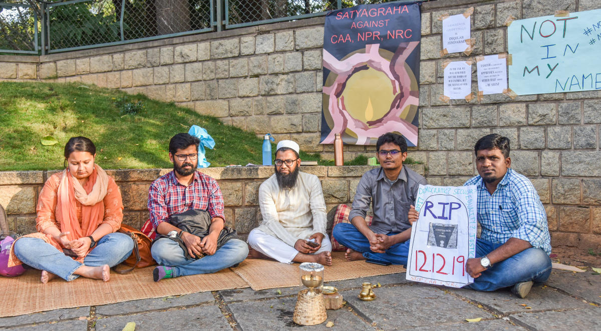 Students and public take part in the vigil against the Citizenship Amendment Act, National Register of Citizenship and National Population Register in front of IIMB on Bannerghatta Road on Monday. DH Photo/S K Dinesh