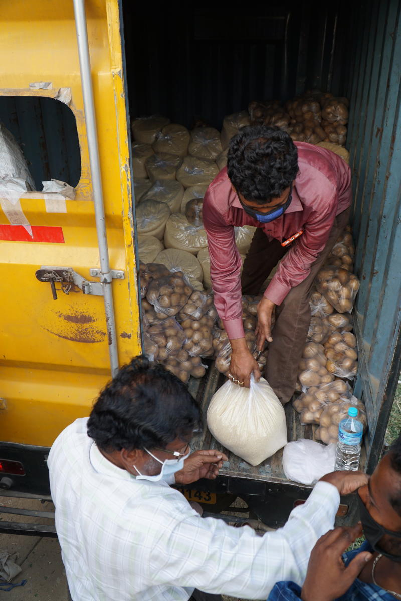 Members of NGO Bharat Gyan Vigyan Samithi hand out ration. 