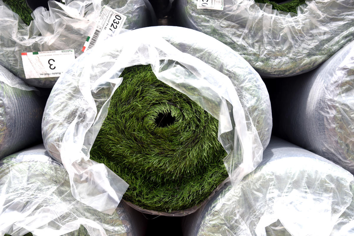 New artificial turf being unloaded at the Bangalore Football Stadium in Bengaluru on Saturday. DH Photo/ S K Dinesh