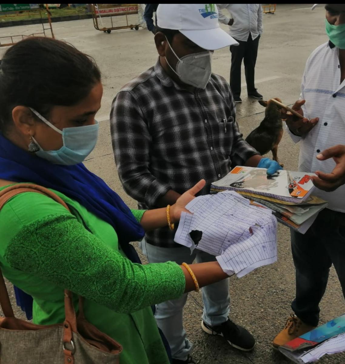 Bengaluru Urban district officials at Attibele health checkpost show logbooks with travellers entry from Tamil Nadu that is drenched due to heavy rains. Special arrangement