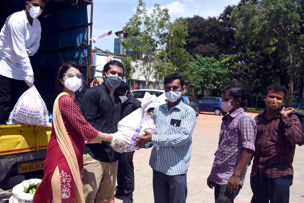ActorsHarshika Poonacha and Bhuvann distribute food grains to the needy in Bengaluru. Photo by S K Dinesh