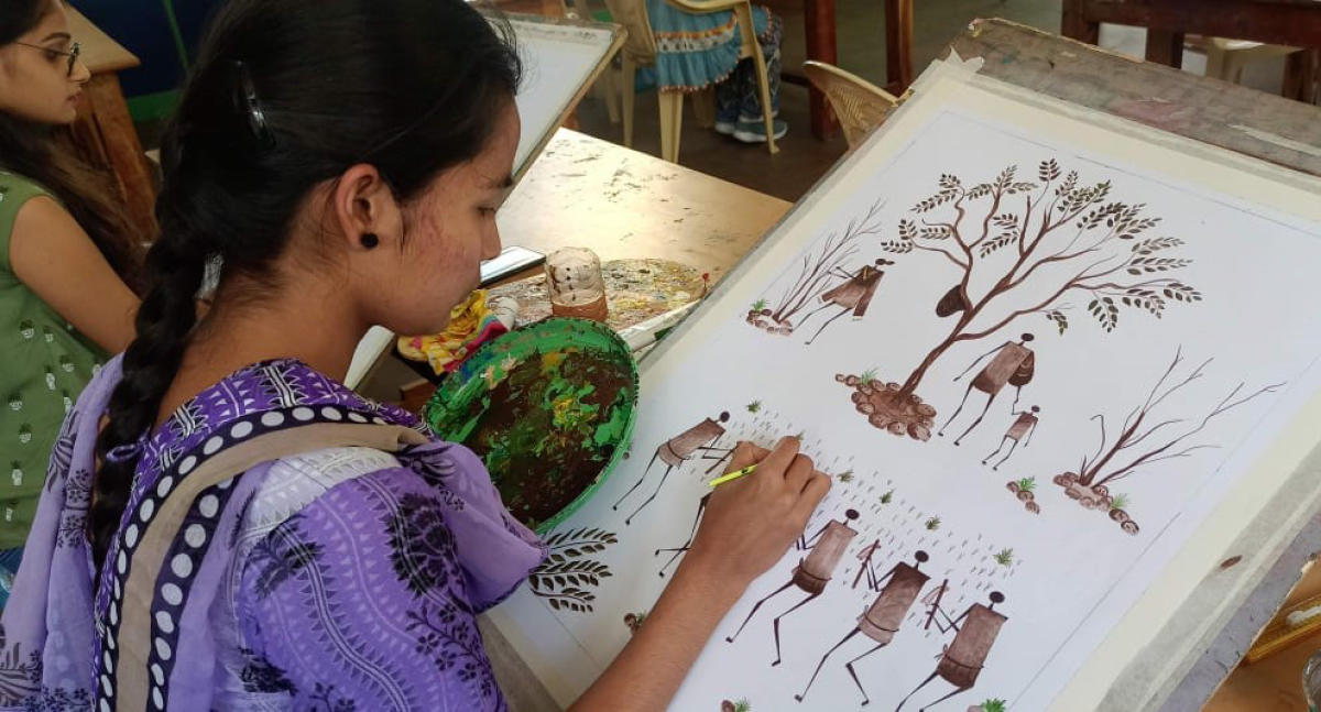 Student working on a Kurumba painting