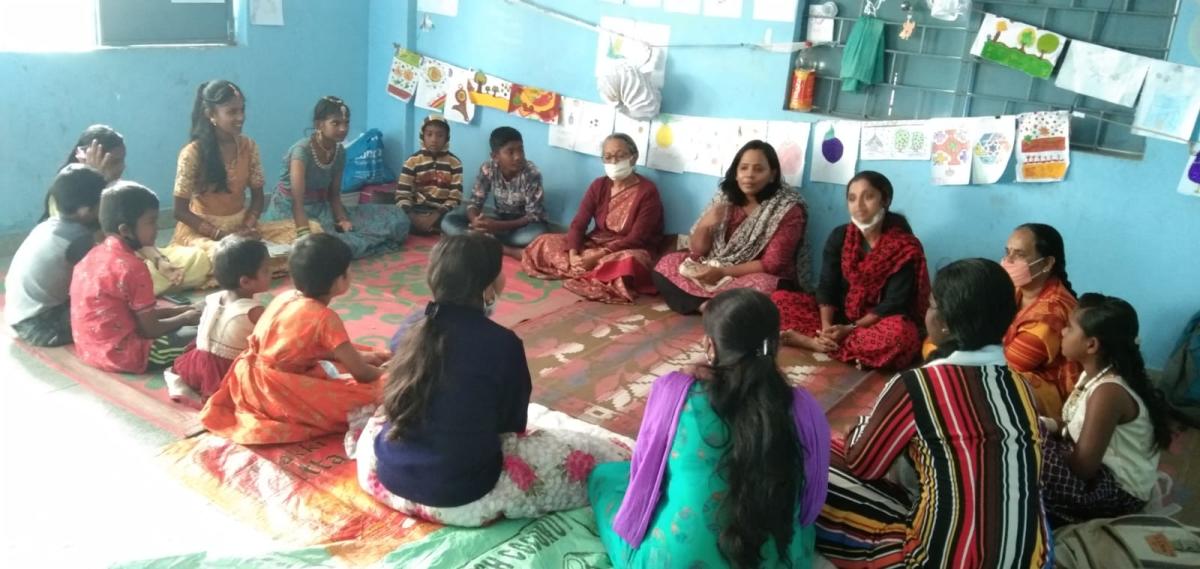 Students engaging in a discussion with educationist Indira Vijaysimha (in sari).