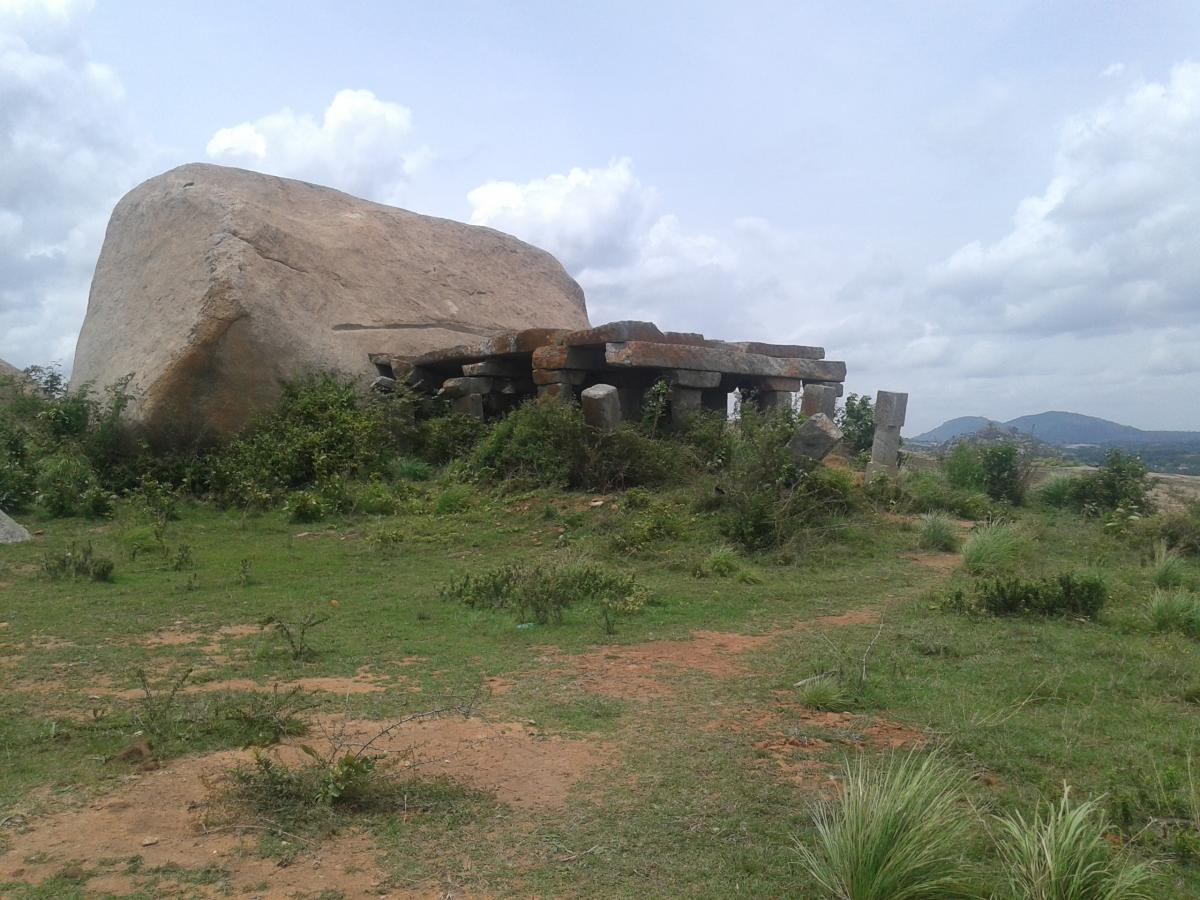 Ruins of a mantapa which houses a tirthankara carved on a boulder.