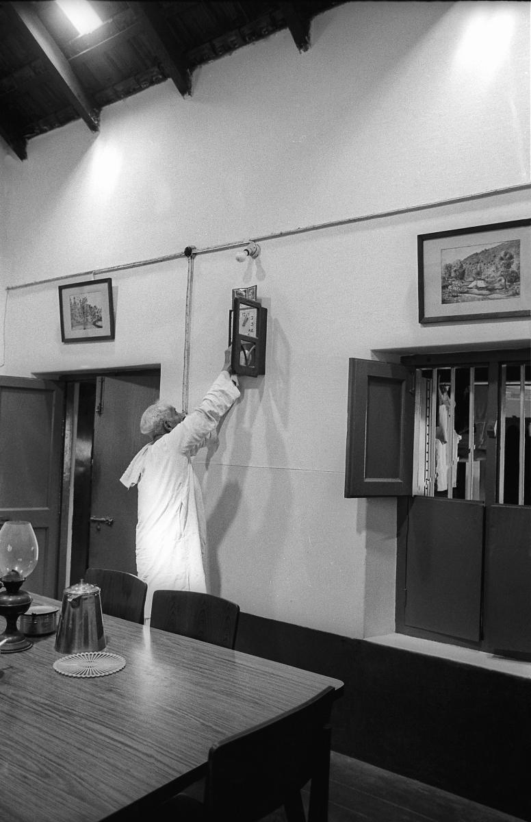 The poet winds up a grandfather clock.