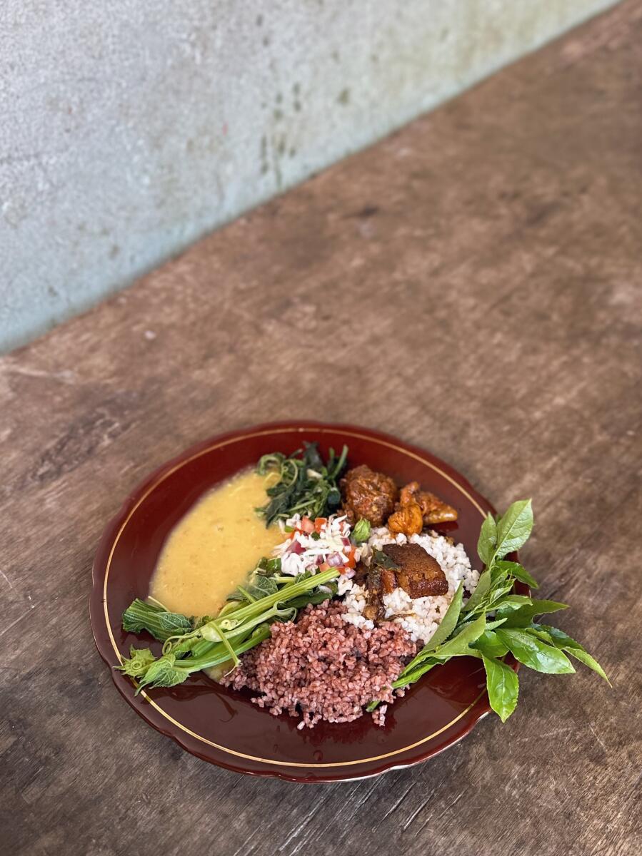 A juicy pork curry cooked in bamboo shoots and served with sticky and red rice is a popular staple dish in Nagaland. PHOTOS BY AUTHOR