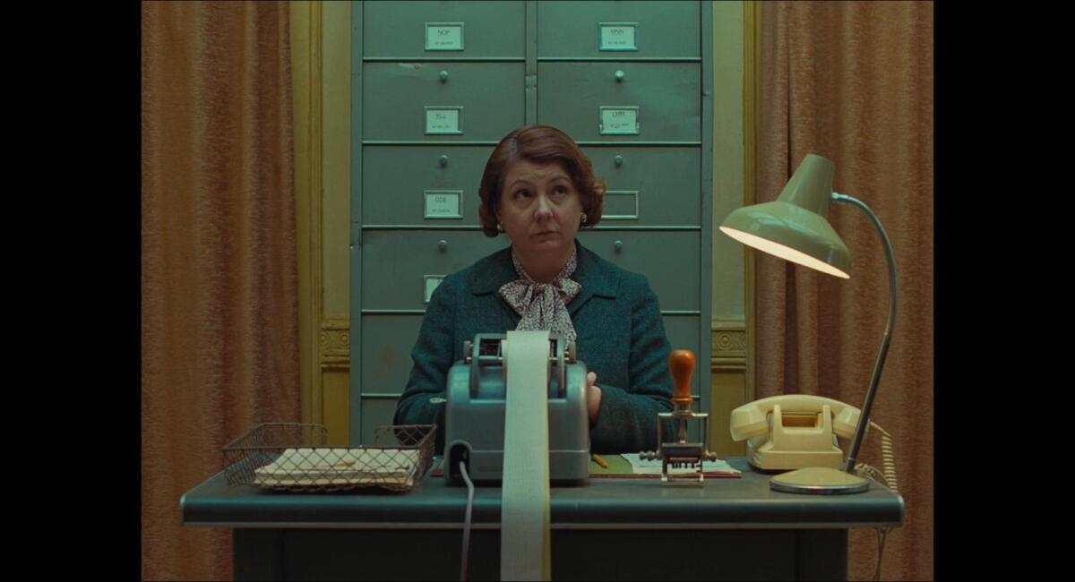 Teal and yellow pastel shades and symmetrical framing in ‘The French Dispatch’ (2021).