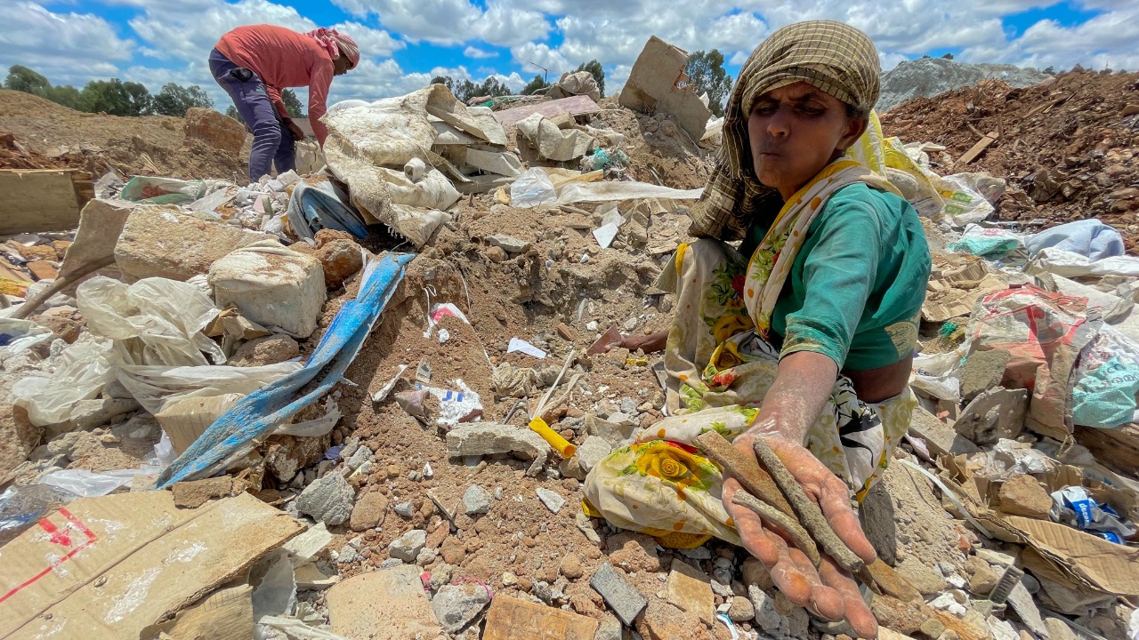 A woman grazing sheep said she had no problem with the landfill or leachate. A few people were busy trying to sort iron and plastic from the construction waste. Credit: DH Photo/ Pushkar V