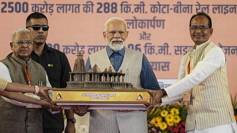<div class="paragraphs"><p>PM Modi being presented a memento by Madhya Pradesh Governor Mangubhai C. Patel and Chief Minister Shivraj Singh Chouhan during the foundation stone laying ceremony of the memorial of Sant Ravidas, in Sagar, Saturday, Aug. 12, 2023.</p></div>