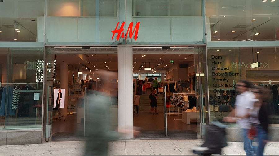<div class="paragraphs"><p> Pedestrians and shoppers walk past a branch of fashion retailer H&M in central Stockholm, Sweden, July 17, 2023. </p></div>