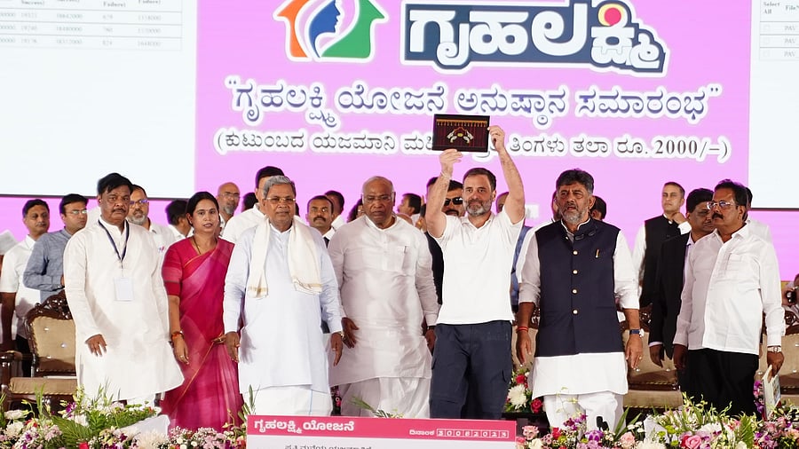 <div class="paragraphs"><p>Congress leader Rahul Gandhi displays the tab from which direct benefit transfer (DBT) was done to beneficiaries of Gruha Lakshmi scheme of Karnataka government, in Mysuru, on Wednesday. </p><p><br></p></div>