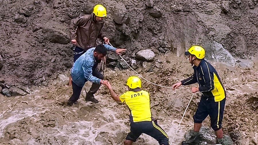 <div class="paragraphs"><p> SDRF personnel conduct a relief and rescue work after heavy monsoon rains, in Tikochi village of Uttarkashi, Monday, Aug. 14, 2023.</p></div>