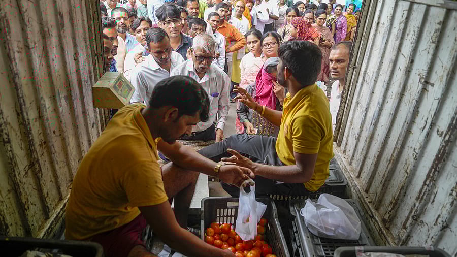 <div class="paragraphs"><p>People buy tomatoes at a discounted rate from a mobile van of National Cooperative Consumers' Federation of India. </p></div>